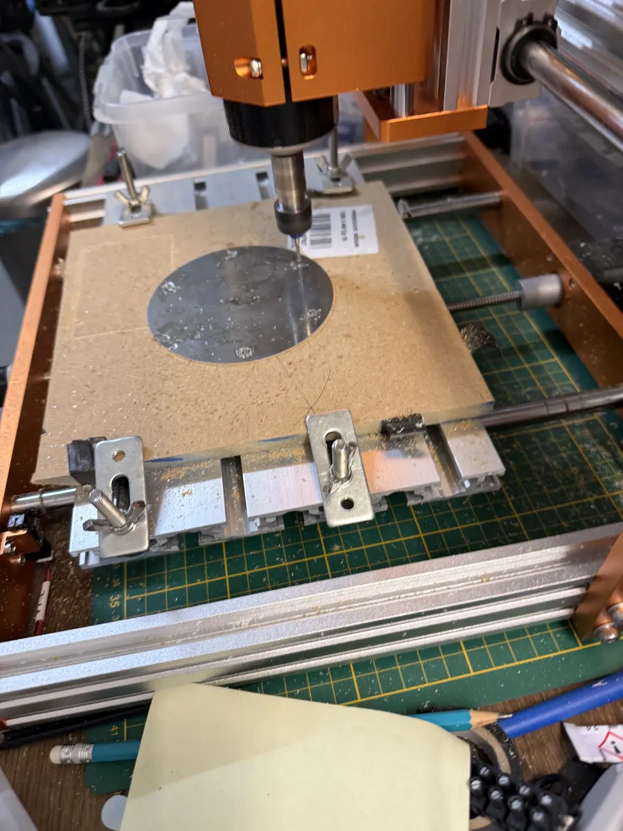 The CNC mill machining an aluminium disc clamped on the spoilboard.